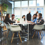 students working around a table in a classroom