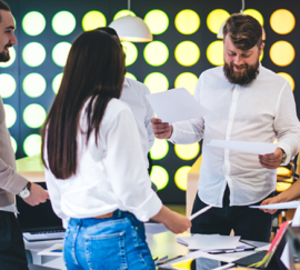 Group of young multiethnic coworkers in modern spacious workplace