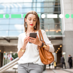 Office worker checking her phone outside of office