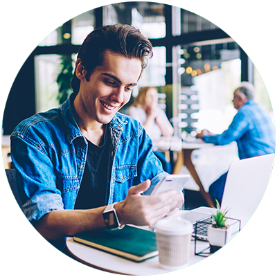 Guy on mobile in a coffee shop